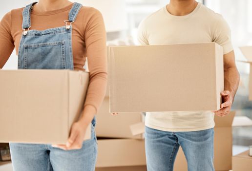 The time felt right for a new start. Closeup shot of an unrecognisable couple carrying boxes while moving house.