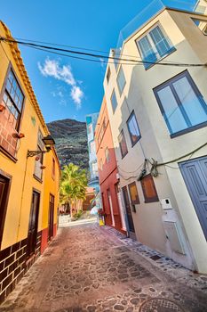 Scenic view of old historic houses, residential buildings, traditional infrastructure in small alleyway, street, road. Tourism, travel destination abroad and overseas in Santa Cruz de La Palma, Spain