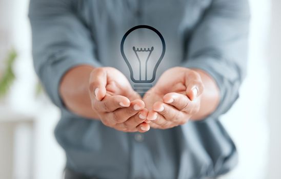 Take care of your energy. an unrecognizable businessperson holding out their hands with a lightbulb placed in it at work.