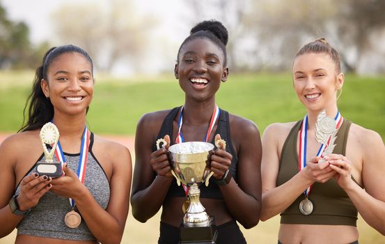Three women, three winners. Cropped portrait of three attractive young female athletes celebrating their victory.