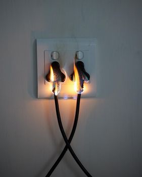 Are you covered. two plugs in a wall socket catching fire.