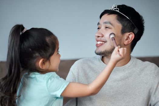 Youre the best looking dad I know. a playful little girl applying make-up to her fathers face.