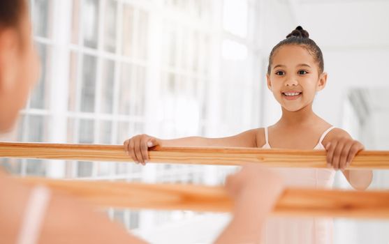 Dream big, dance bigger. a little girl practicing ballet in a dance studio.