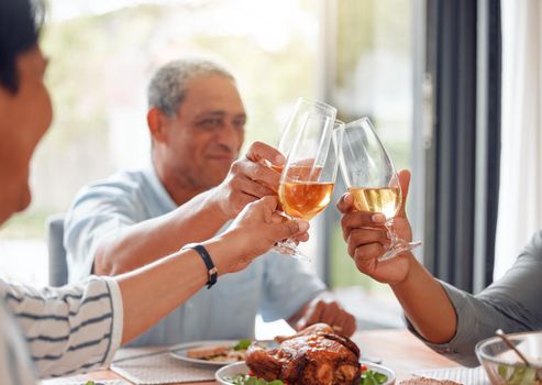 Cheers to family. a family toasting with wine glasses at home.