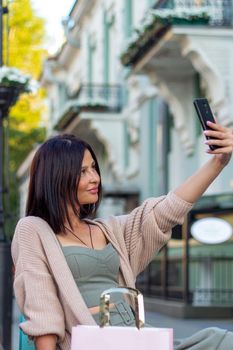 Young beautiful woman smiling going to the shops using smartphone