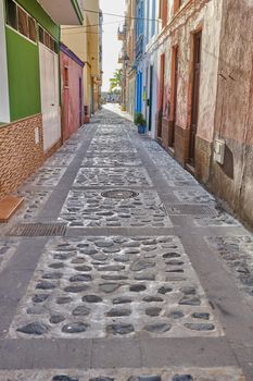 City street view of residential houses or buildings in leading alleyway in Santa Cruz, La Palma, Spain. Historical spanish and colonial architecture in tropical village and famous tourism destination