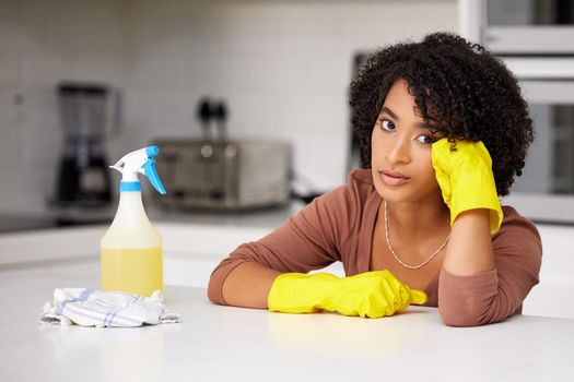 Im getting kinda tired of repeating the same process. a woman looking unhappy while doing housework.