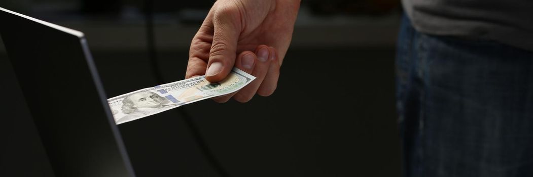 Man invest money through computer screen, put banknote to online bank