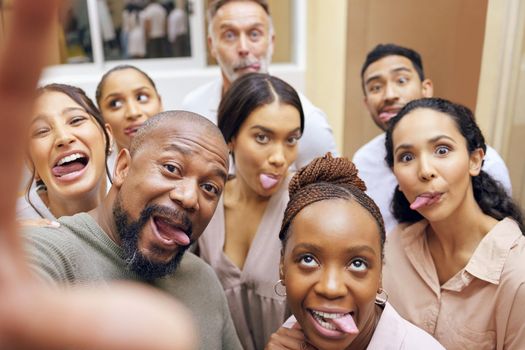 Office fun with business friends. a group of colleagues taking a selfie in a office.