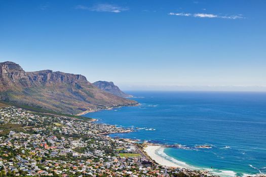 Aerial panorama photo of Camps Bay. Aerial view of town near sea against sky.
