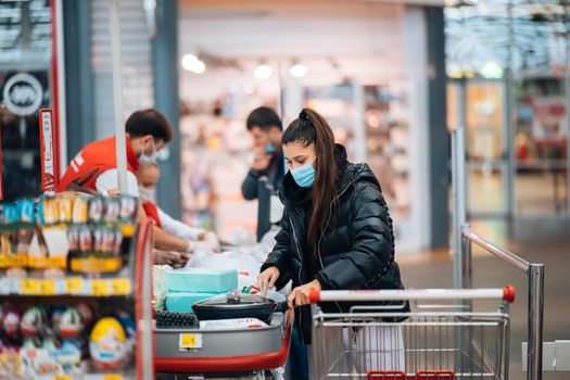 Young woman buying goods in a supermarket