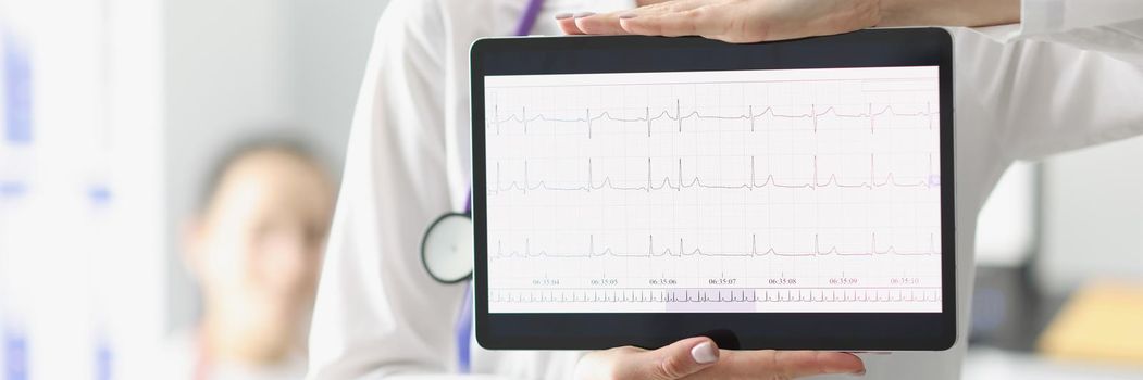 Doctor showing digital tablet screen with heart cardiogram result