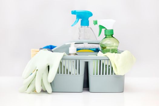 The bacteria busting start pack. a basket full of cleaning supplies on a table.
