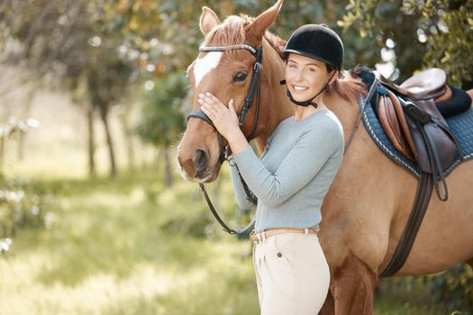 Horses change lives. an attractive young woman standing with her horse in a forest.
