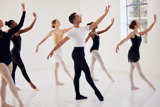 Dance for yourself. a group of ballet dancers practicing a routine in a dance studio.