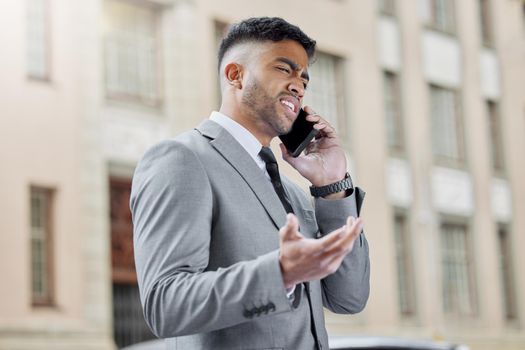 What do you mean you cant. a handsome young businessman standing in the city and looking confused while using his cellphone.