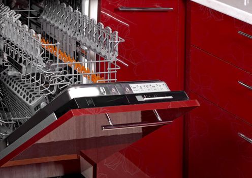 New modern empty dishwasher built into a beautiful red kitchen