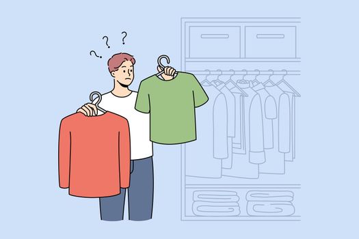 Man choose what to wear in wardrobe