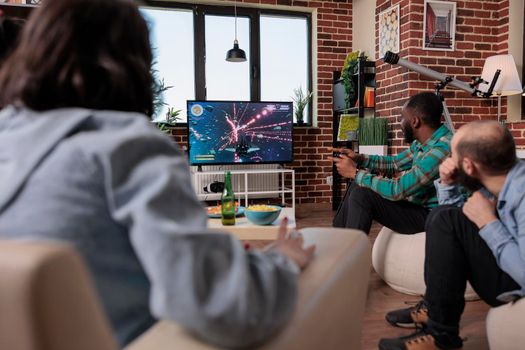 African american man playing video games on tv console