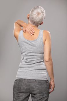 Backache pain in back, senior woman with  body and muscle problems