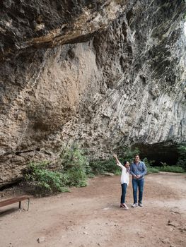 Happy young couple excited about the cave that they discovered