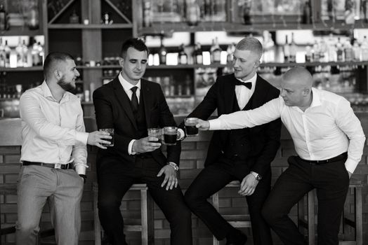 groom in a brown suit and his friends