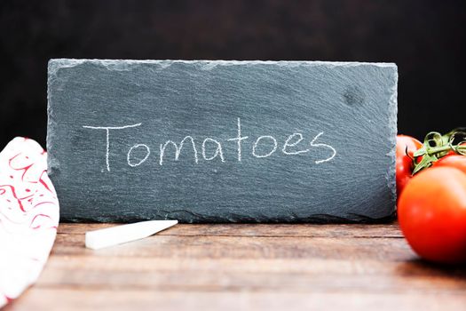 Tomatoes Written on Chalkboard Sign