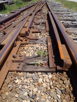 Railroad tracks running into distance with a track switch