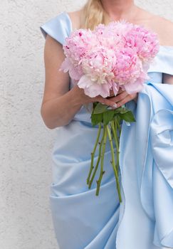 bride in a blue wedding dress with a bouquet of pink peonies, pastel paradise