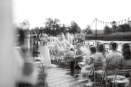 wedding ceremony on a high pier near the river