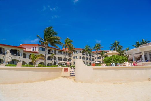 Hotel on a sandy beach on a sunny day in Playa del Carmen, Mexico