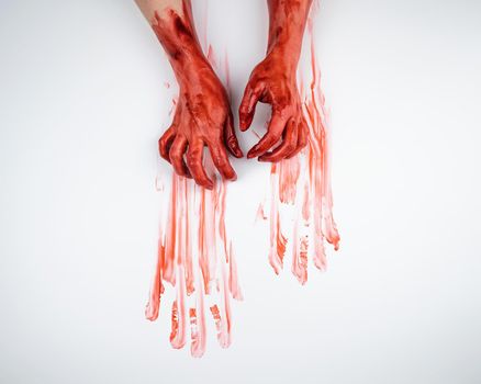 Female hands in blood on a white background.
