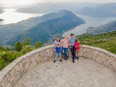 happy friends enjoys the view of Kotor. Montenegro. Bay of Kotor, Gulf of Kotor, Boka Kotorska and walled old city. Travel to Montenegro concept. Fortifications of Kotor is on UNESCO World Heritage