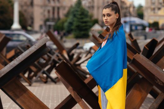Young woman covered with the Ukrainian flag