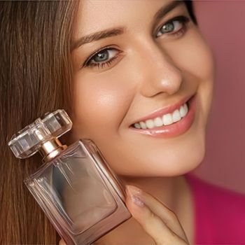 Perfume, beauty product and cosmetics model face portrait on pink background, beautiful woman holding fragrance bottle with floral feminine scent, fashion and makeup concept