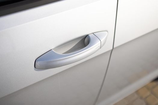 Keyless entry car door handle with keyless go touch sensor. Car door handle. Access button. Automatic opening of a car door without a key. Exterior design of a new electric luxury car