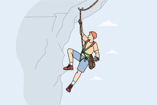 Man climbing mountain with special equipment