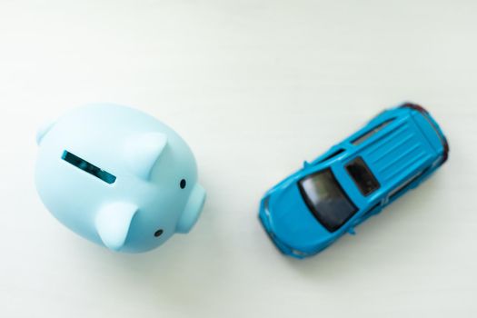 Pig moneybox and toy car isolated on white.