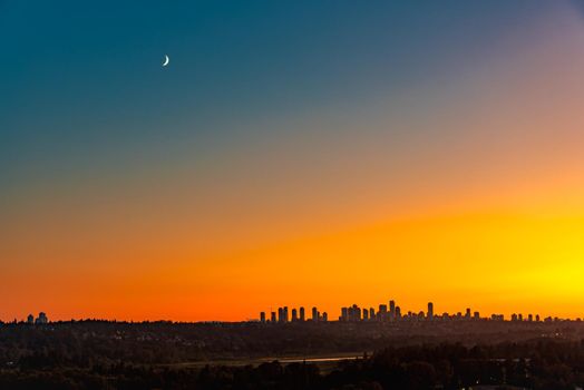 Metrotown district under the moon on sunset sky background