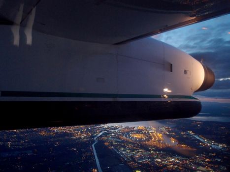 Plane Wing flies over City of Seattle at night