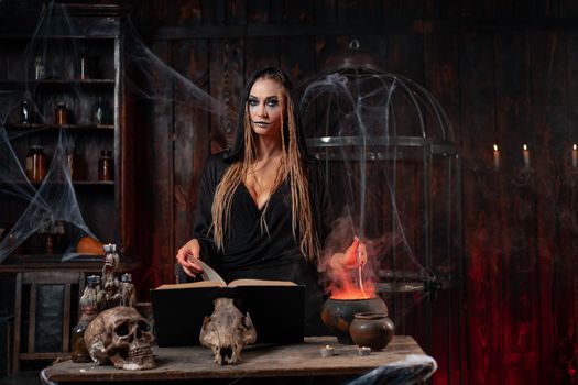 Halloween, witch use magic book and cauldron prepare poison or love potion