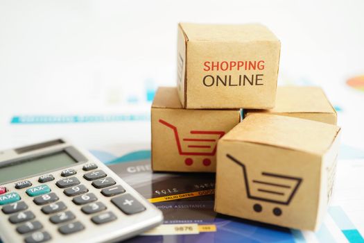 Online shopping, Shopping cart box on calculator, import export, finance commerce.