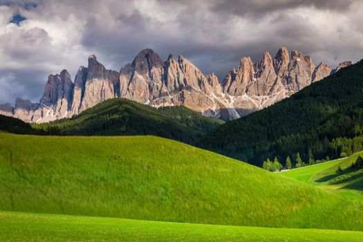 Idyllic Landscape of St Magdalena countryside in Dolomites at dramatic sky, Northern Italy.