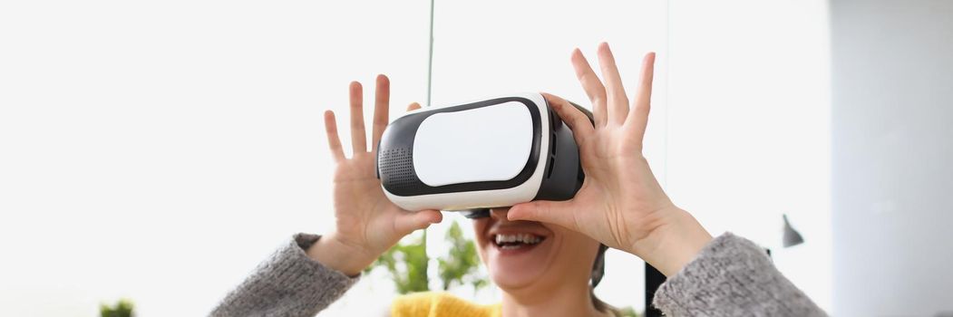 Woman wear vr glasses modern device at home and laugh