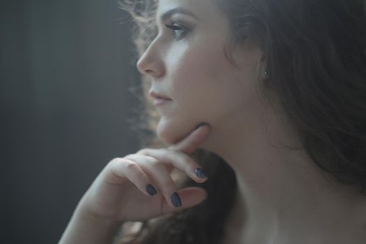 Portrait of a beautiful sensual young woman with curly hair.