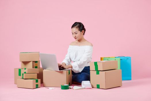 woman working at home office packaging on background