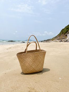 Photo of straw beach bag on exotic sand beach