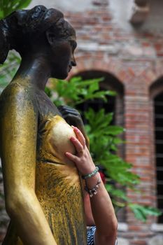 Woman rubs Juliet's chest for good luck