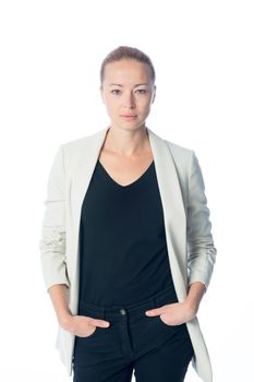 Casual business woman standing against white background.