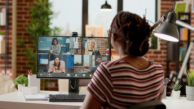 Businesswoman using online videocall conference to talk to colleagues
